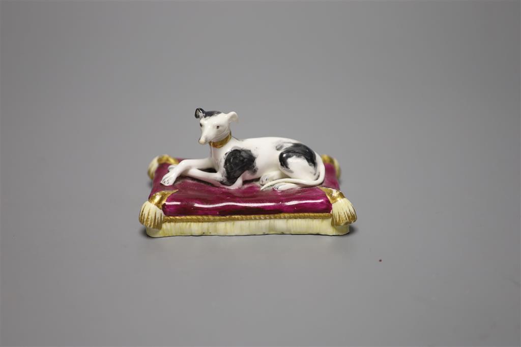 A Minton porcelain greyhound, recumbent on cushion, width 20cm